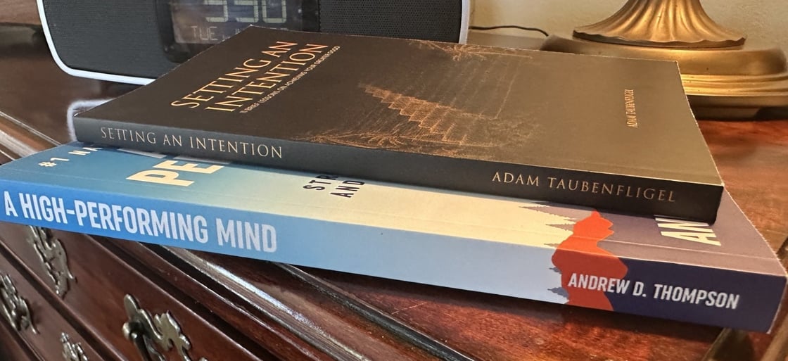 Picture of books on Gary Keller's nightstand of Setting an Intention by Adam Taubenfligel, A High-Performing Mind by Andrew Thompson, and also promoting The 5 Types of Wealth by Sahil Bloom